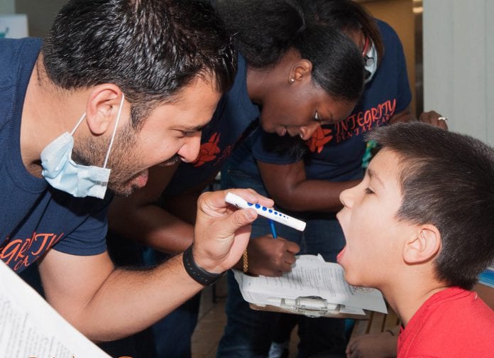Bookbag GiveAway dental exam