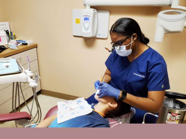 Dental hygienist Ladonna Hodge providing dental care for school