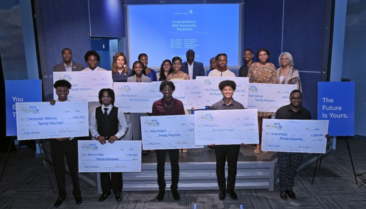 10 recipients of NextEra Energy Scholarship for Black Students in SECME proudly hold up their $20,000 college scholarship check from Florida Power & Light Company inside the Museum of Discovery and Science in Fort Lauderdale, FL.