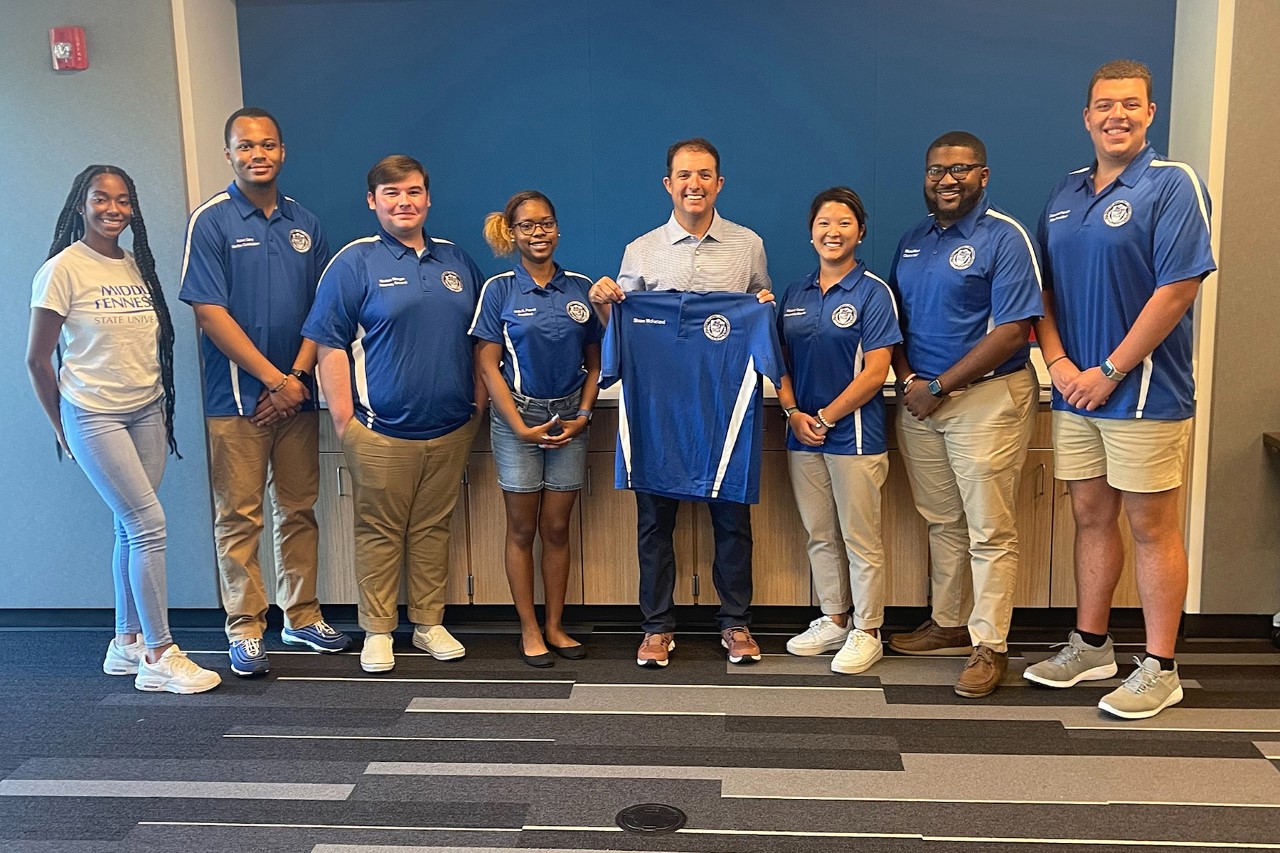 Murfreesboro Mayor Shane McFarland, center, an MTSU alumnus and former student government president, poses with the MTSU Student Government Association Executive Board after receiving an SGA polo shirt with his name on it. McFarland spoke at the Center for Student Involvement and Leadership retreat Wednesday, Aug. 3, at Murfreesboro Police Department headquarters. (MTSU photo by Danny Kelley)