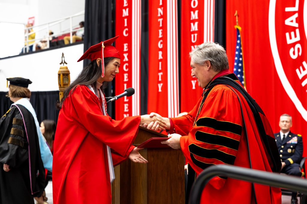 Junior health and human performance major Bo ram Kim shakes hands with APSU President Mike Licari during the university’s December 2024 commencement ceremony, where she earned her associate degree.