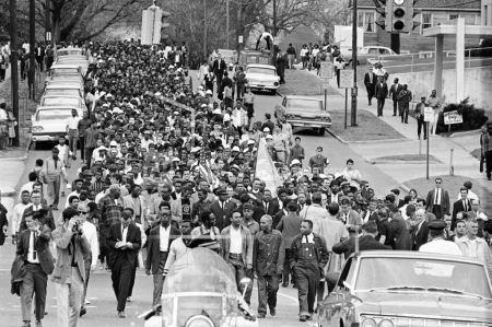 FILE - In this March 17, 1965, file photo, demonstrators walk to the courthouse behind the Rev. Martin Luther King Jr. in Montgomery, Ala. The march was to protest treatment of demonstrators by police during an attempted march. At front and center of march in white shirt is Andrew Young. (AP Photo/File)