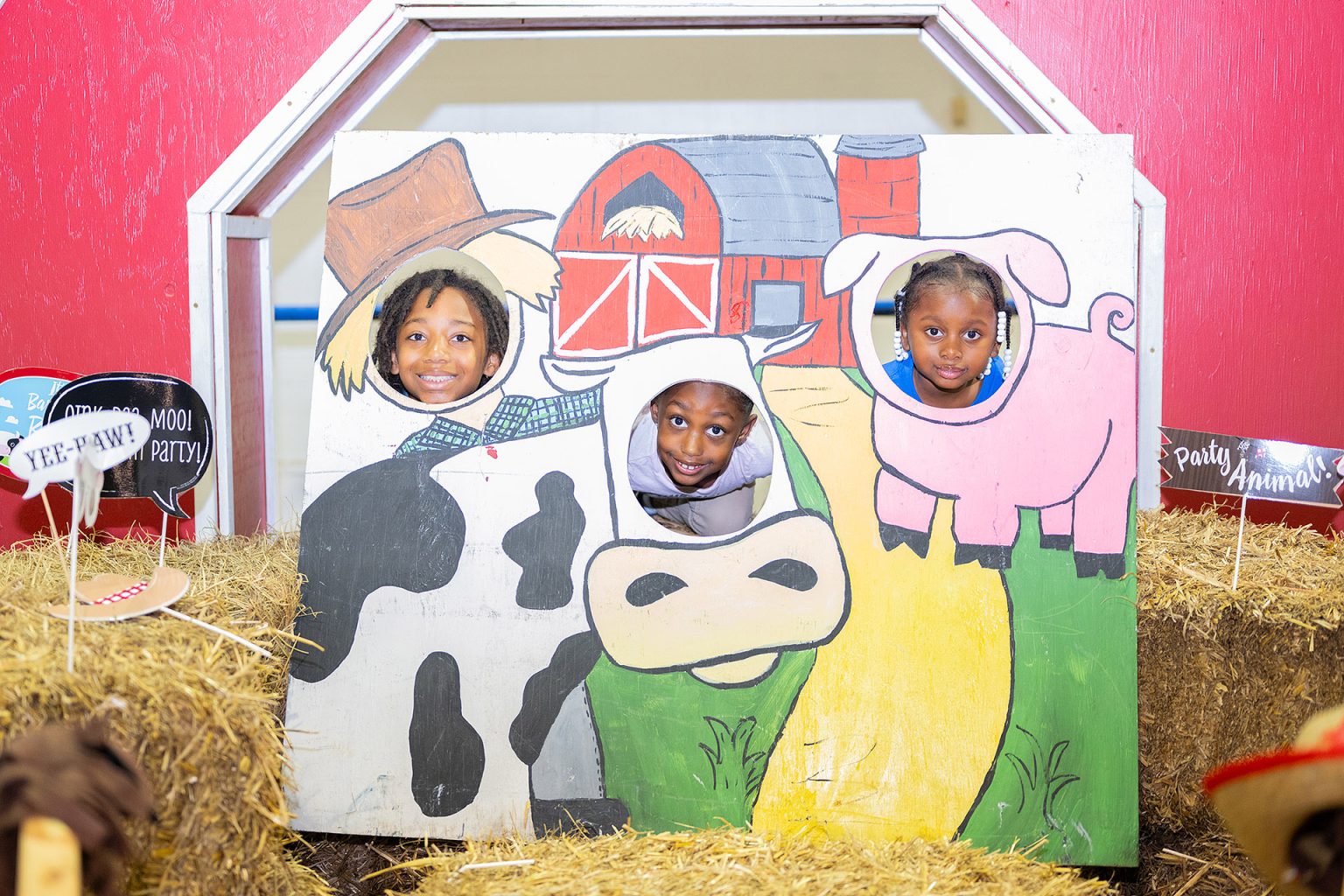 A trio of youngsters pose for the camera within a farm-themed display at the 2024 “Saddle Up” fundraiser inside the MTSU Tennessee Livestock Center on the campus of Middle Tennessee State University. This year’s family-friendly event in support of the Ann Campbell Early Learning Center will be held from 8:30 to 11:30 a.m. Saturday, April 19, at the livestock center located at 1720 Greenland Drive. (MTSU file photo by Cat Curtis Murphy)