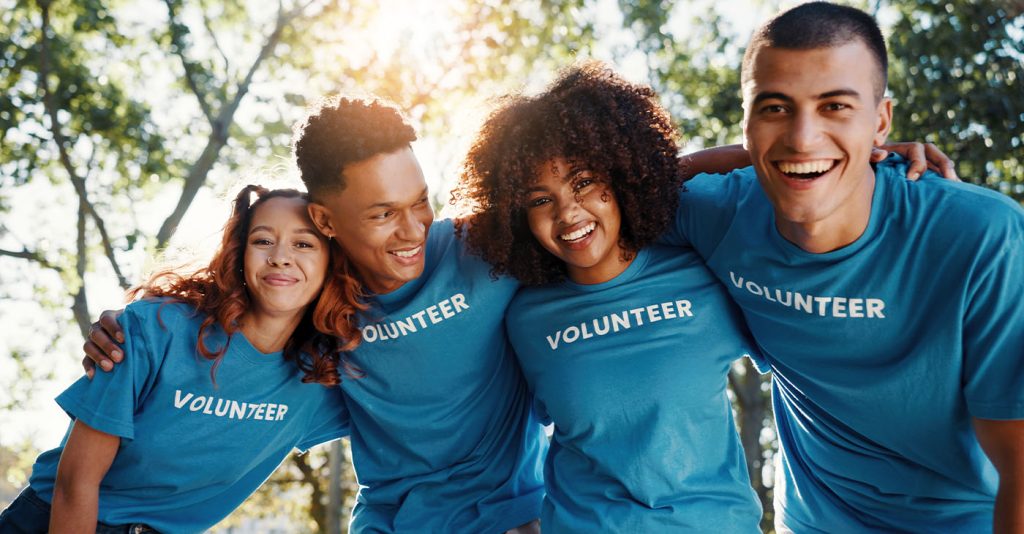 Volunteer, friends and portrait of people in park for recycle program, earth day or social responsibility. Environment, climate change and NGO with group in nature for non profit, cleaning or charity (Photo by Jacob Wackerhausen)