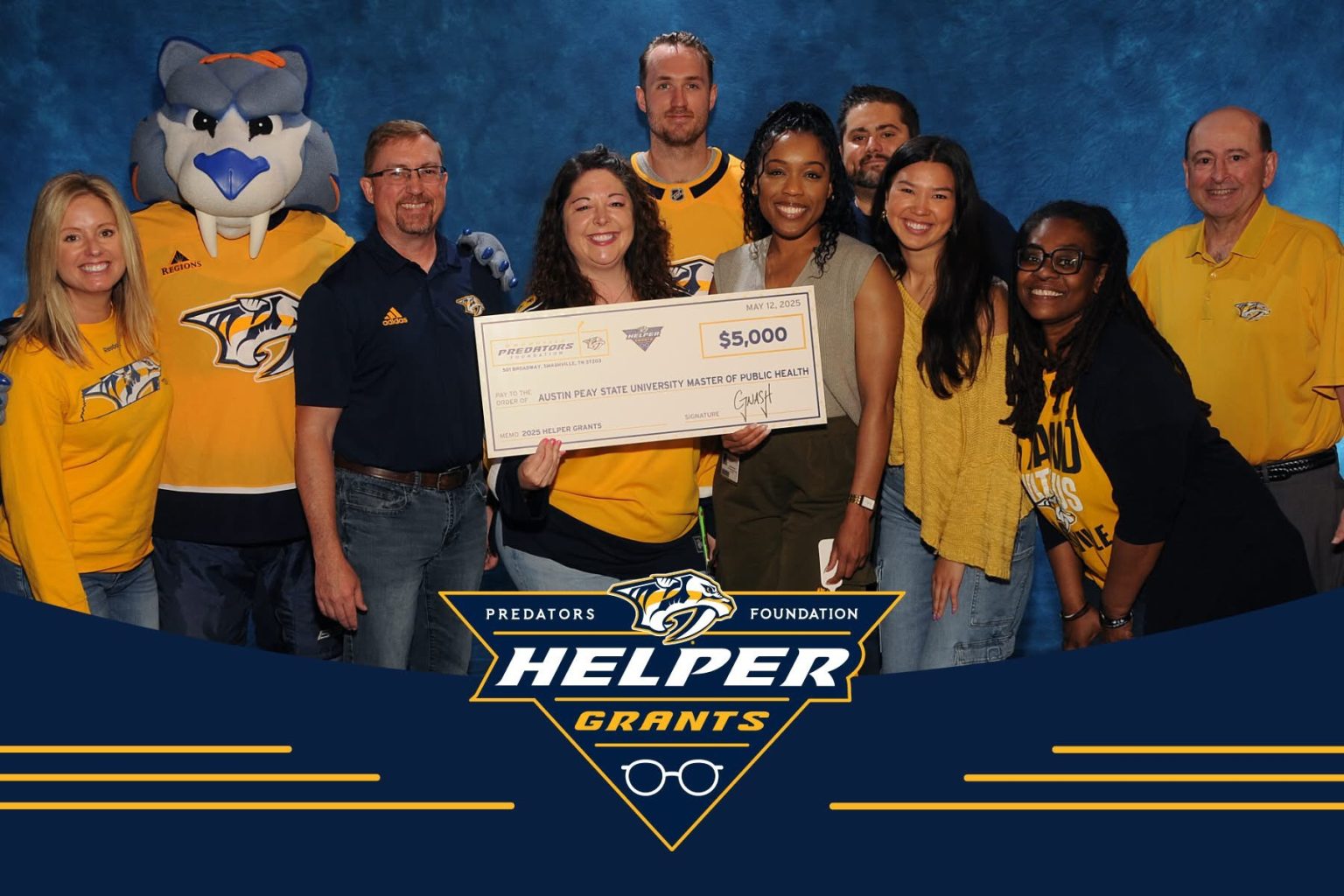 Austin Peay State University faculty and staff representatives receive a $5,000 Helper Grant from the Nashville Predators Foundation to support the Community LIFT Project, an early childhood literacy initiative. | Contributed photo