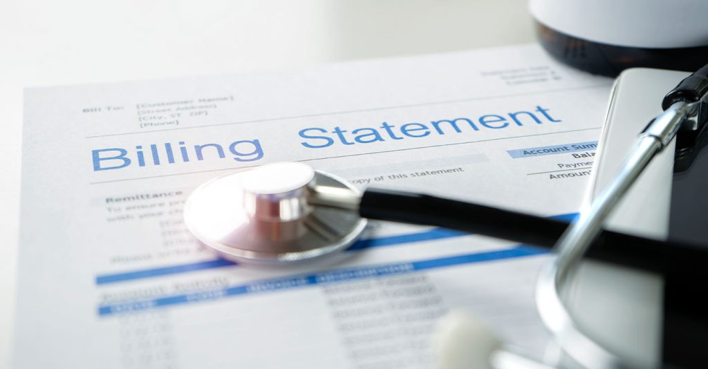 Health care billing statement with stethoscope, bottle of medicine for doctor's work in medical center stone background.