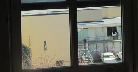 View of Lorraine Hotel, from second floor bathroom window in the boarding house from where James Earl Ray was alleged to have fired the fatal shot at Martin Luther King, Jr., Boarding house view of Lorraine Motel balcony. Photo: Mr. Littlehand / Wikimedia Commons.