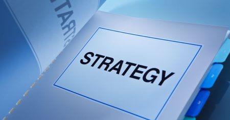 A still life of a working business plan book. A fundamental document that guide a business venture, its strategy, positioning, market, administration, management and all aspect of any business.