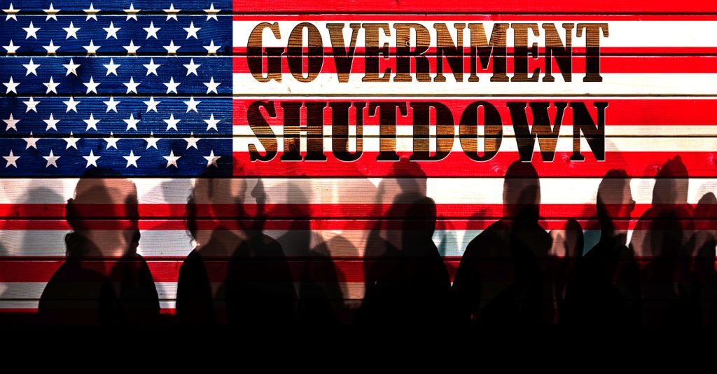 Lot of people shadows against USA flagged fence, shutdown concept