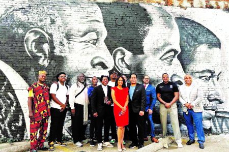 Marie Pizano, founder/president of The MVP3 Foundation, and Kelly Christopher “KC” Amos are flanked by supporters who witnessed the unveiling of “Three Generations,” a mural honoring KC’s father, the late actor John Amos. Photo by Larry Hubbard
