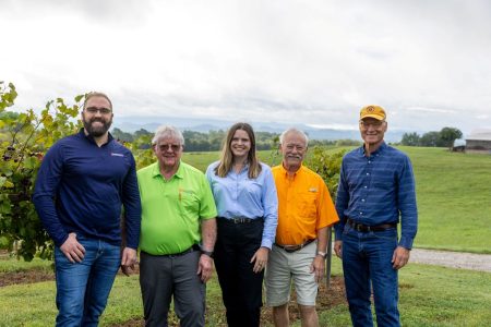 Members of the University of Tennessee Institute of Agriculture’s viticulture team are, from left, Pierre Davadant, AgResearch scientist and assistant professor in the UT Herbert College of Agriculture; continuing in a post-retirement position, David Lockwood, professor and Extension fruit and nut specialist; and Annie Vogel, assistant professor and UT Extension fruit specialist. Joining them at Tsali Notch Vineyard in Madisonville, Tennessee, are Don Collier, owner of the Apple Barn Winery and Hard Cider Company of Sevierville, Tennessee; and, at right, Cary Cox, owner of Tsali Notch. Both Collier and Cox serve on Gov. Bill Lee’s Wine and Grape Board alongside Lockwood, underscoring their leadership in advancing Tennessee’s grape and wine industries. Photo by Raffe Lazarian, courtesy UTIA